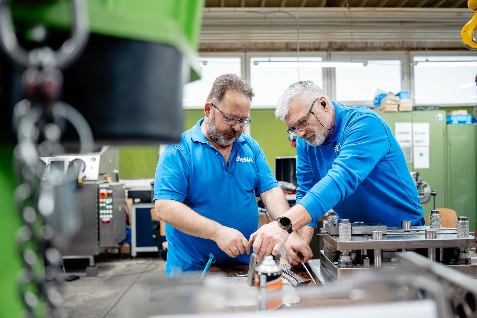 men in a factory looking at a machine